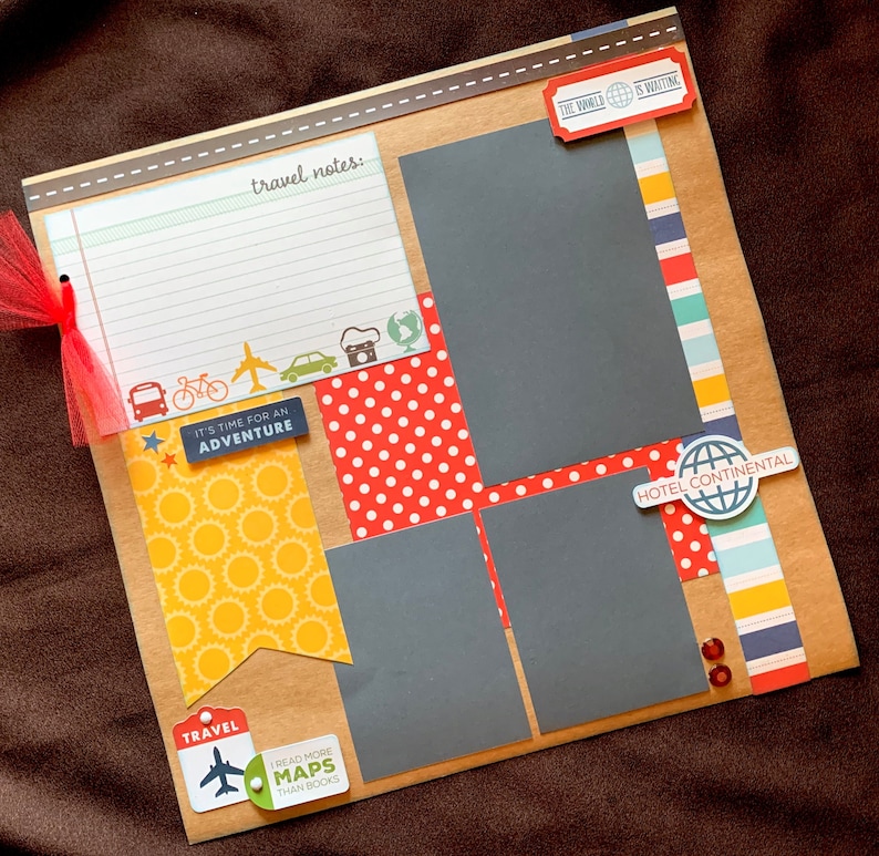 May include: A scrapbook page with a travel theme. It features a variety of patterned papers, including red and white polka dots, yellow with a sunburst pattern, and blue and white stripes. There are also several cutouts, including a plane, a bicycle, a camera, and a globe. The text on the page includes "It's time for an adventure", "Travel", "Read more maps than books", "The world is waiting", and "Hotel Continental".