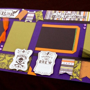 May include: Purple scrapbook page with a Halloween theme. The page has several cutouts, including a bat, a witch's cauldron, and a skull and crossbones. The page also has several patterned papers, including a black and white damask pattern, a green and orange chevron pattern, and a brown and orange floral pattern. The page also has several text boxes, including one that says "Thrilling" and another that says "Happy Halloween".