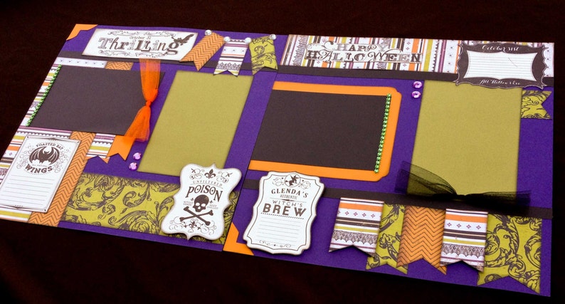 May include: Purple scrapbook page with a Halloween theme. The page has several cutouts, including a bat, a witch's cauldron, and a skull and crossbones. The page also has several patterned papers, including a black and white damask pattern, a green and orange chevron pattern, and a brown and orange floral pattern. The page also has several text boxes, including one that says "Thrilling" and another that says "Happy Halloween".