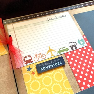 May include: A scrapbook page with a travel theme. The page has a lined section for writing travel notes, a red polka dot patterned paper, a yellow paper with a sunburst pattern, and a black paper with the text "It's time for an adventure".