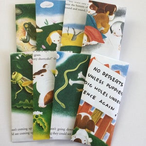 May include: A collection of illustrated bookmarks featuring whimsical scenes with animals and text. The bookmarks depict a frog, puppies, a grasshopper, and a snake. One bookmark has the text: "NO DESSERTS UNLESS PUPPIES DIG HOLES UNDER FENCE AGAIN."