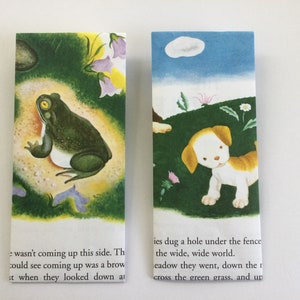 May include: Two rectangular bookmarks with illustrations. One shows a green frog with a yellow eye, the other a puppy in a field. Text is visible at the bottom of each bookmark.