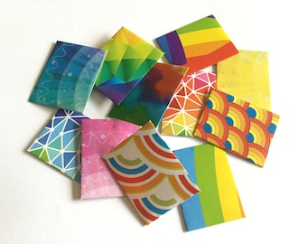 May include: A collection of colorful envelopes with different geometric and abstract patterns. The envelopes are made of paper and have a variety of colors, including blue, green, yellow, orange, and red.