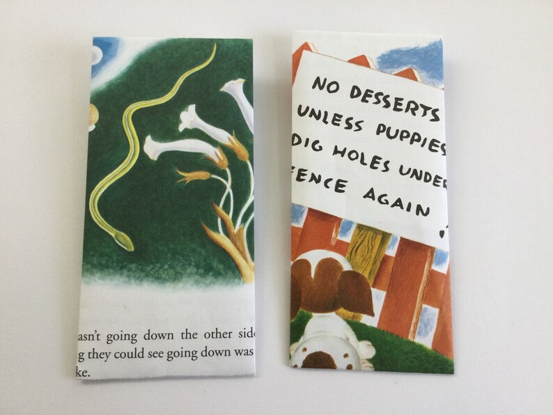 May include: Two illustrated bookmarks. One features a green snake, white flowers, and text. The other shows a puppy and a sign that reads "NO DESSERTS UNLESS PUPPIES DIG HOLES UNDER FENCE AGAIN."