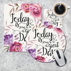 May include: A set of three floral mouse mats with the text "Today is going to be a great day" on each. The mouse mats are white with pink and purple flowers.