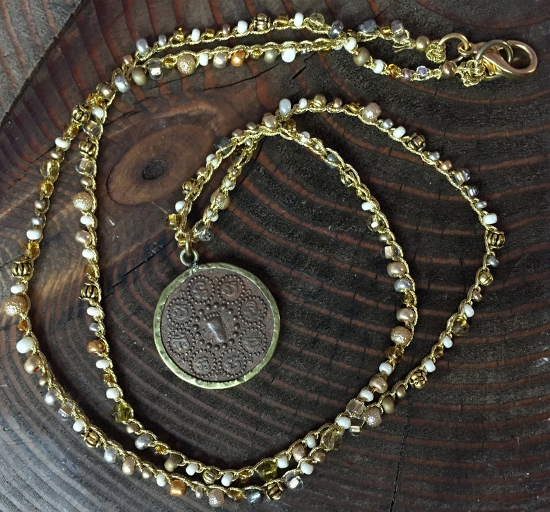 Seed Beaded Necklace in gold white and yellow Brass Beads with a small double sided coin pendent
