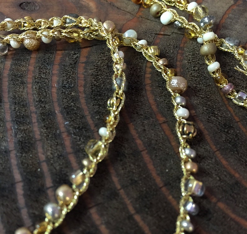 Seed Beaded Necklace in gold white and yellow Brass Beads with a small double sided coin pendent