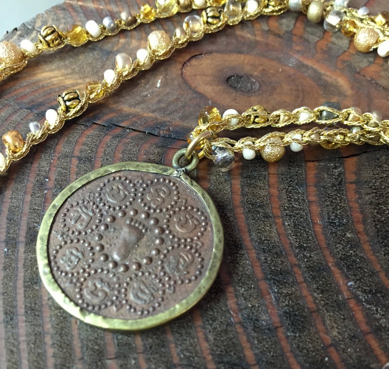 Seed Beaded Necklace in gold white and yellow Brass Beads with a small double sided coin pendent