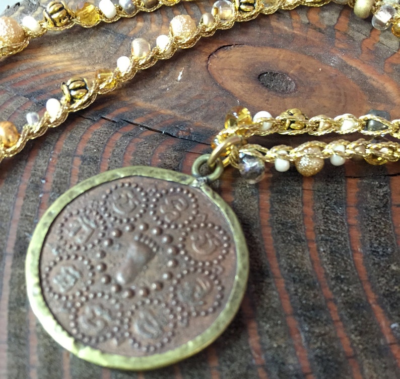 Seed Beaded Necklace in gold white and yellow Brass Beads with a small double sided coin pendent