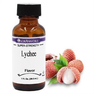 May include: A brown glass bottle of LorAnn Oils Lychee flavor with a black cap. The label reads "Lychee Flavor" and "1 FL. Oz. (29.5 mL)." Next to the bottle are several red lychees, some with green leaves.