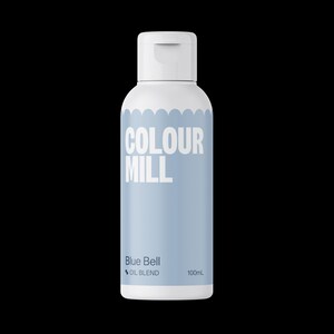 May include: A white bottle with a flip-top cap, featuring the text "COLOUR MILL" in white. The bottle has a light blue label with "Blue Bell OIL BLEND" and "100mL" printed on it. The bottle is against a black background.