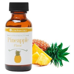 May include: A glass bottle of LorAnn Oils Pineapple Flavor with a black cap. The label features the text "Pineapple Flavor" and a pineapple illustration. Slices of fresh pineapple and a pineapple top are also shown.