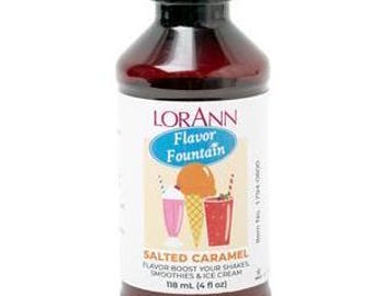 May include: A brown glass bottle with a red label that says "LORANN Flavor Fountain Salted Caramel Flavor Boost Your Shakes Smoothies & Ice Cream 118 ml (4 fl oz)"