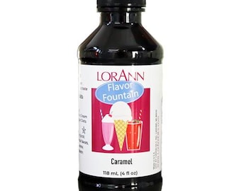 May include: A glass bottle of Lorann Flavor Fountain Caramel flavoring. The bottle is dark brown with a black cap. The label is white with blue and red accents. It shows a cartoon image of a milkshake, ice cream cone, and a soda. The label reads "Lorann Flavor Fountain Caramel 118 mL (4 fl oz)"