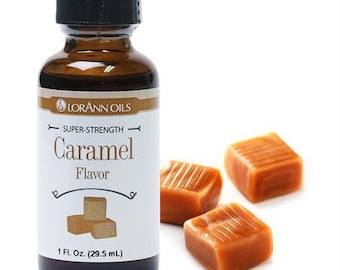 May include: A brown glass bottle with a black cap, labeled "LORANN OILS" and "SUPER-STRENGTH Caramel Flavor". The bottle contains 1 fl. oz. (29.5 ml) of caramel flavoring. The image also shows four caramel candies.