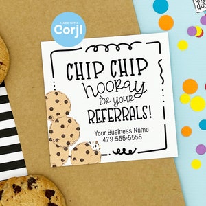 May include: A white card with a black border and a cartoon image of chocolate chip cookies. The text on the card reads "CHIP CHIP hooray for your REFERRALS!" and includes a business name and phone number.