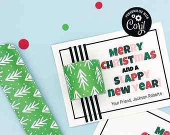 May include: A Christmas card with a green and white patterned paper tube attached to it. The card reads "Merry Christmas and a Slappy New Year!" with the text in red, pink, and green. The card is signed "Your Friend, Jackson Roberts".