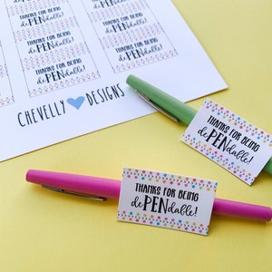May include: A set of printable gift tags with colorful confetti and the text "Thanks for being dePENdable!" on a white background. The tags are next to two pens, one pink and one green.