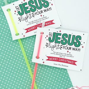 May include: Printable Christmas cards with glow sticks attached. The cards feature the text "Let Jesus light your way!" with a Bible verse and the greeting "Merry Christmas!"