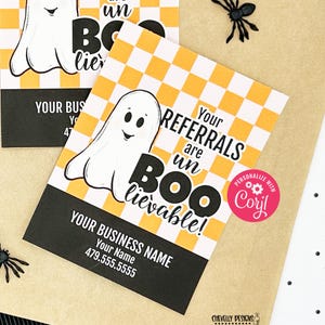 May include: A Halloween-themed business card with a ghost graphic and the text "Your Referrals are unBOOlievable!"  The card has a black and yellow checkered background and a pink circle with the text "PERSONALIZE WITH CORYL".