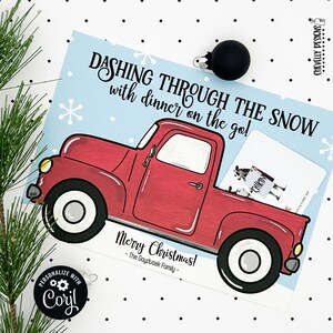 May include: A red pickup truck with a white snowflake design on a blue background. The truck has a white 'CHIKIN' sign in the back. The text reads 'Dashing through the snow with dinner on the go! Merry Christmas! - The Goydusek Family -'.