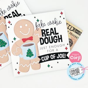 May include: A gingerbread man holding a cup of hot chocolate with a Christmas tree design. The card reads "fake cookie REAL DOUGH JUST ENOUGH FOR A CUP OF JOE!" with a pink circle that says "PERSONALIZE WITH Corjl" and a white circle that says "DO NOT COPY CHEVelly designs ORIGINAL DESIGN".