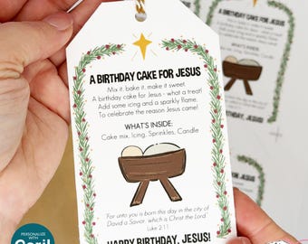May include: A white gift tag with the text "A Birthday Cake for Jesus" and a decorative border of green leaves and red berries. The tag includes a drawing of a manger and the words "Happy Birthday, Jesus!"