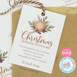 May include: A white tag with a watercolor illustration of a Christmas-themed simmering potpourri recipe. The tag has the text "Christmas Simmering Potpourri" and instructions for making the potpourri. The tag is 3 inches by 4 inches.