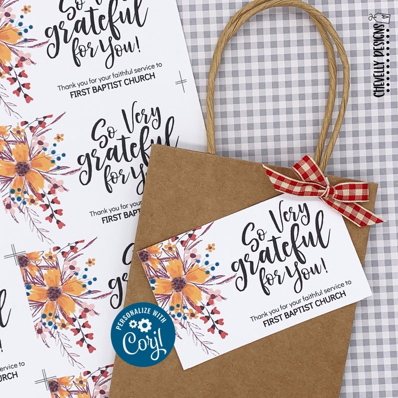 May include: A brown paper gift bag with a red and white checked ribbon. The bag has a white tag attached to it with a floral design and the text "So Very Grateful for You!" and "Thank you for your faithful service to FIRST BAPTIST CHURCH".