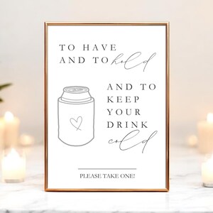 May include: A rectangular sign in a thin copper frame featuring black text that reads TO HAVE AND TO hold AND TO KEEP YOUR DRINK cold and PLEASE TAKE ONE! with a line drawing of a beverage can cooler featuring a small heart outline.