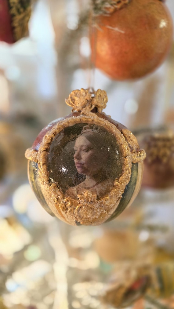 An oversized, hand-painted Queen Victoria bauble that feels like a tiny museum artifact hanging on your tree — genuinely one-of-a-kind Victorian portraiture craft.