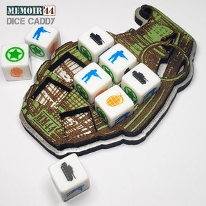 May include: A wooden dice caddy shaped like a grenade, with six dice inside. The dice are white with different symbols, including a star, a tank, a soldier, and a grenade. The caddy is labeled "Memoir '44 Dice Caddy".