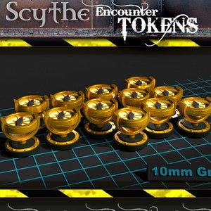 May include: Twelve gold-coloured encounter tokens for the Scythe board game. Each token features a compass design with a red centre and a black arrow. The tokens are arranged on a black and blue grid with the text "10mm Grid" and "Includes 12 Encounter Tokens" visible.