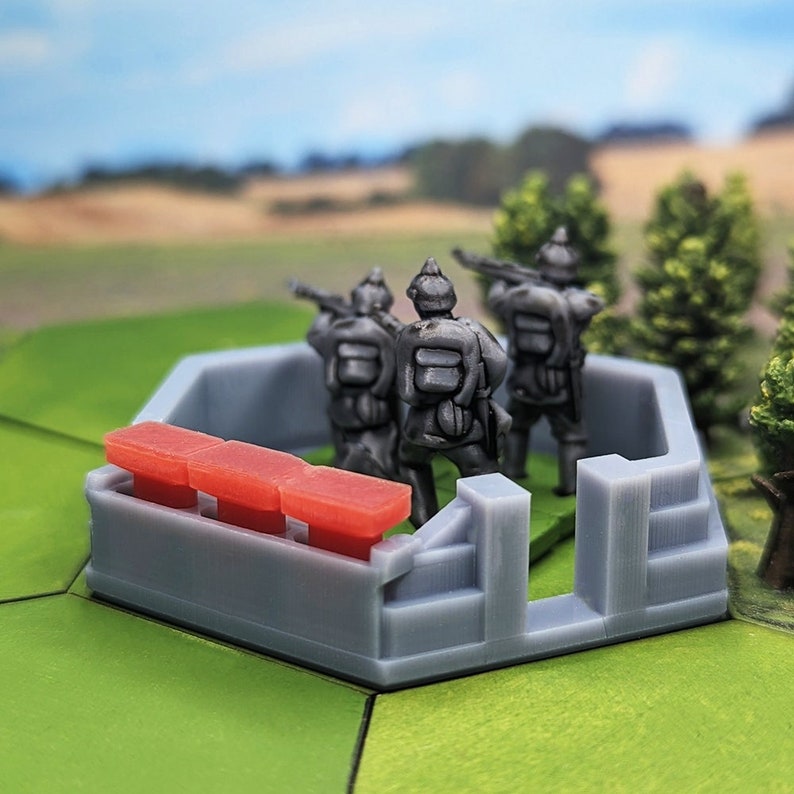 May include: A gray plastic miniature wargaming terrain piece with a trench and three red sandbags. Three gray plastic miniature soldiers are standing in the trench, facing forward, holding rifles.