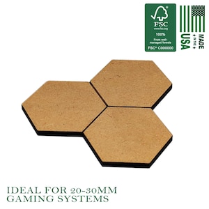 May include: Three hexagonal wooden tiles, ideal for gaming systems. The tiles are a light brown color and are arranged together. The image also includes the text "IDEAL FOR 20-30MM GAMING SYSTEMS" and the FSC and Made in the USA logos.