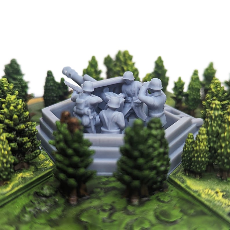 May include: A gray plastic model of a World War II German anti-aircraft gun with four soldiers manning the gun. The gun is positioned on a gray plastic base with a hexagonal shape. The model is surrounded by small green trees.