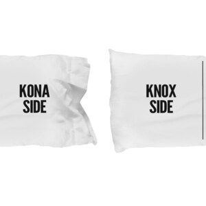 May include: Two white pillowcases with black text. One pillowcase says "MY SIDE" and "KONA SIDE". The other pillowcase says "MY SIDE" and "KNOX SIDE".