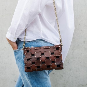 brown leather clutch with a shoulder strap