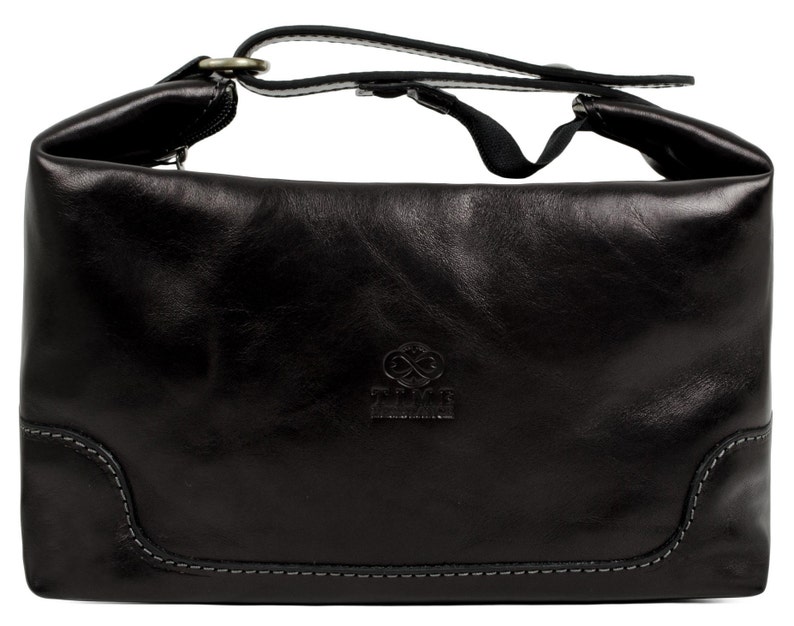 May include: Black leather bag with a fold-over top and a single strap. The bag has a small logo on the front that says "Full Grain Leather".