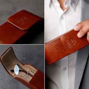 May include: A cognac brown leather glasses case with a magnetic flap closure. The exterior features an embossed logo reading TIME RESISTANT with an infinity symbol. The interior is lined with a light beige fabric and contains round metal glasses.