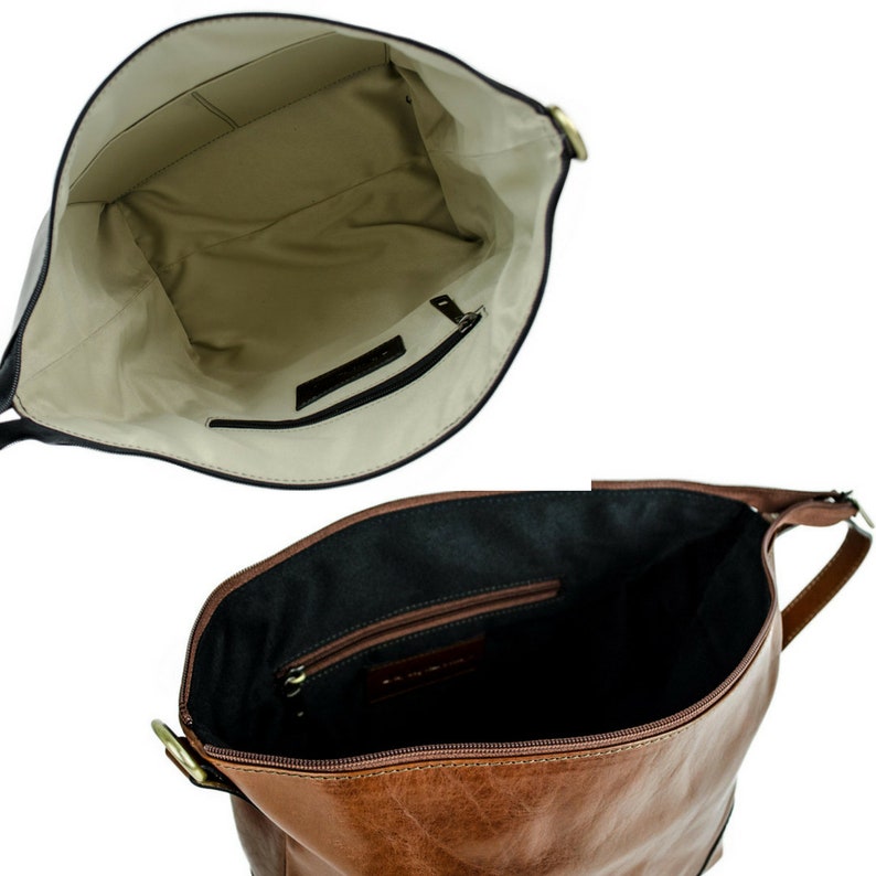 May include: Inside view of a brown leather tote bag with a zippered pocket and a smaller pocket on the inside. The bag has a brown leather strap.