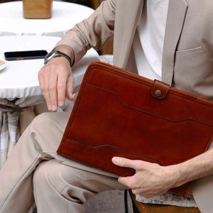 A leather portfolio document case laptop case with a snap closure