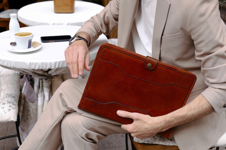 A leather portfolio document case laptop case with a snap closure