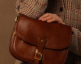 Bolsa transversal em couro bovino de flor integral, curtido vegetalmente, com alça ajustável, ideal para presente feminino.