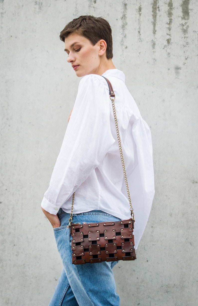 brown leather clutch with a shoulder strap