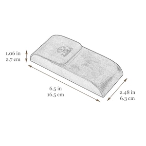 May include: A rectangular, textured gray eyeglass case with a flap closure featuring a logo. Dimensions are 6.5 inches long, 2.48 inches wide, and 1.06 inches high. The case has rounded edges and a smooth, consistent surface finish throughout.