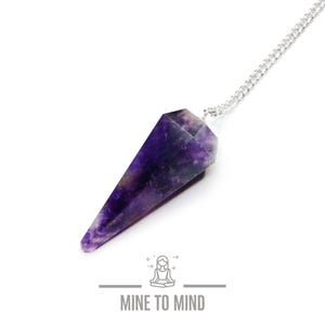 May include: Amethyst crystal pendulum with a silver chain. The pendulum is a deep purple colour and has a pointed tip.