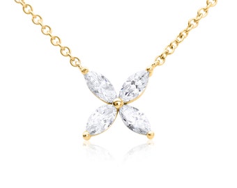 May include: A gold chain necklace with a pendant featuring four marquise-shaped diamonds set in a flower design.