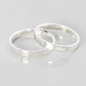 May include: Two silver rings with the names "Jude" and "Asher" engraved on them.