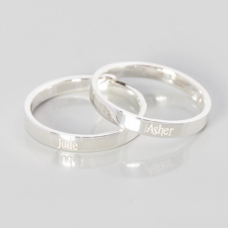 May include: Two silver rings with the names "Jude" and "Asher" engraved on them.